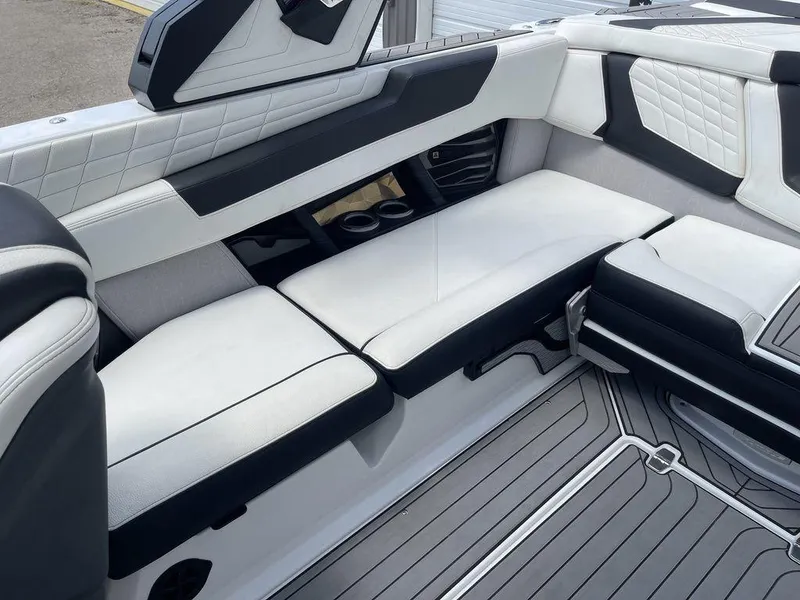 Slide: The Image of 2021 Nautique Super Air Nautique G23 interior seating with white and black upholstery. - 10