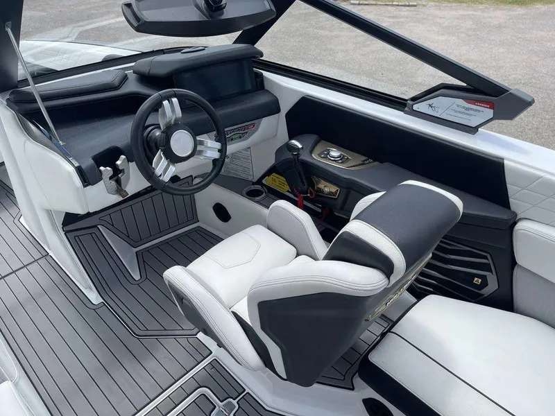 Slide: The Image of 2021 Nautique Super Air Nautique G23 cockpit with modern steering wheel and dashboard. - 11