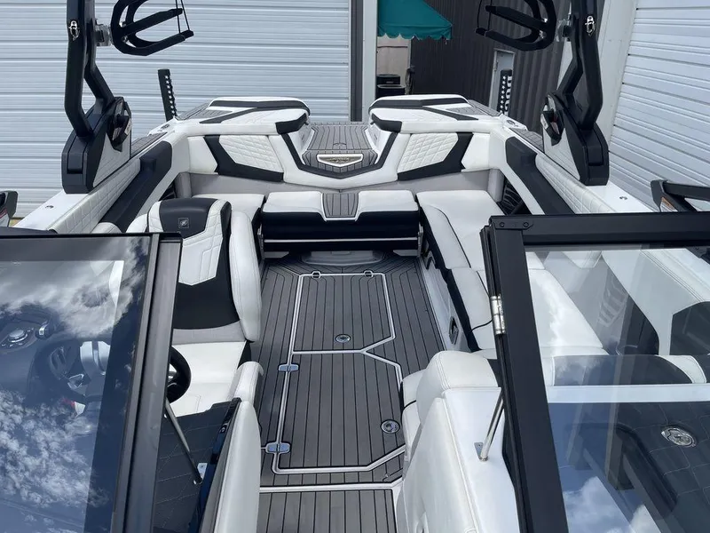 Slide: The Image of 2021 Nautique Super Air Nautique G23 interior with white and black seating, open bow design. - 12