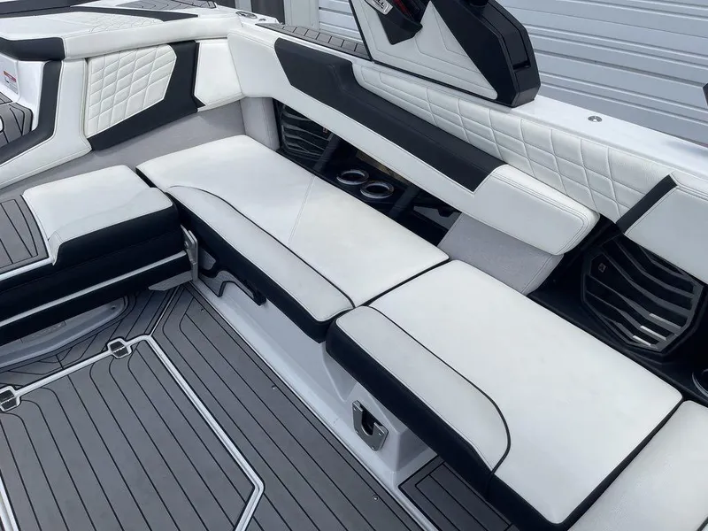 Slide: The Image of 2021 Nautique Super Air Nautique G23 interior seating with white and black upholstery. - 13