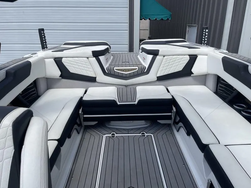 Slide: The Image of 2021 Nautique Super Air Nautique G23 boat interior with white and black seating. - 14