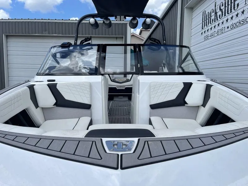Slide: The Image of 2021 Nautique Super Air Nautique G23 boat interior with white and black seating. - 6