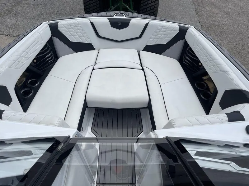 Slide: The Image of 2021 Nautique Super Air Nautique G23 boat interior with white cushioned seating. - 8