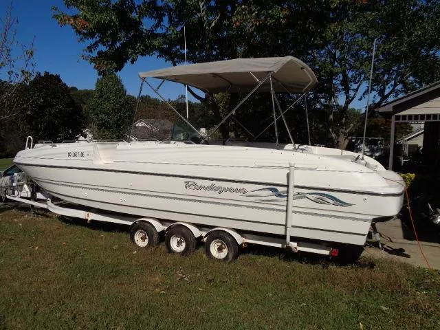 Slide: The Image of 1998 Bayliner 2659 Rendezvous boat on a trailer in a grassy yard. - 3