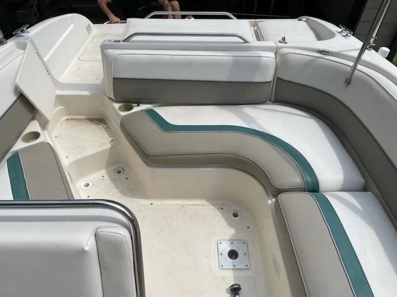 Slide: The Image of 1998 Bayliner 2659 Rendezvous boat interior with white and green seating. - 6