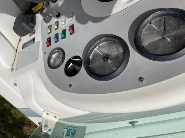 Slide: The Image of 1998 Bayliner 2659 Rendezvous boat dashboard with gauges and control switches. - 8