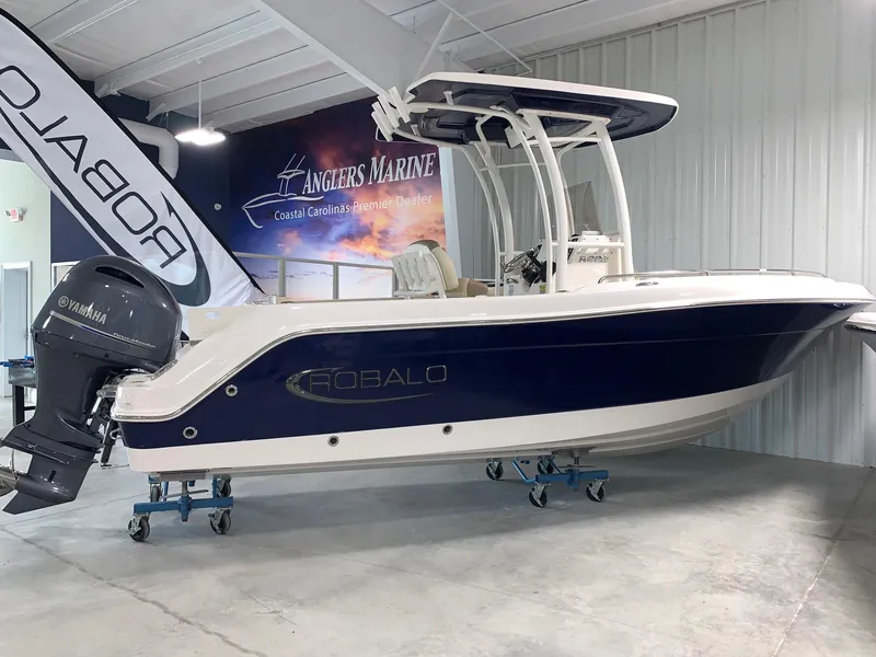 The Image of 2024 Robalo R222 Explorer boat displayed indoors at Anglers Marine dealership. - 0