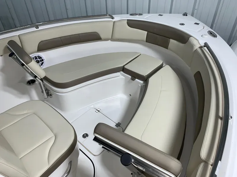 Slide: The Image of 2024 Robalo R222 Explorer boat interior with beige and white seating. - 13