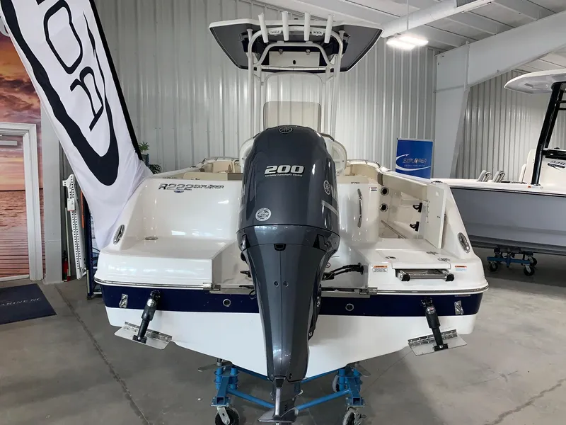 Slide: The Image of 2024 Robalo R222 Explorer boat with 200 HP engine in showroom. - 2