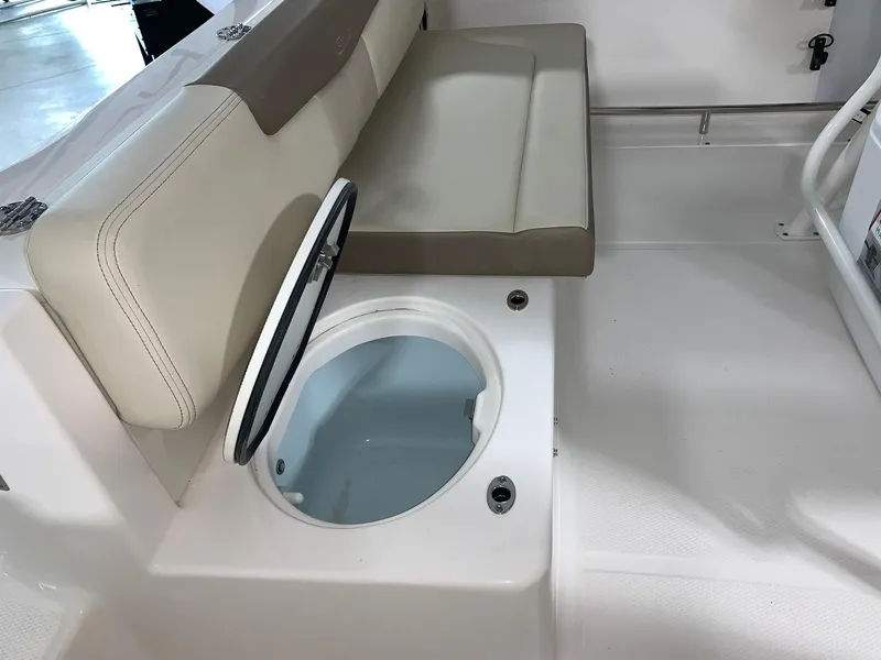 Slide: The Image of 2024 Robalo R222 Explorer boat interior with storage compartment and cushioned seating. - 7