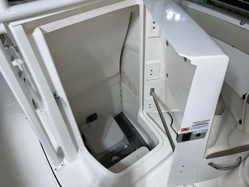 Slide: The Image of 2024 Robalo R222 Explorer storage compartment with open hatch. - 11