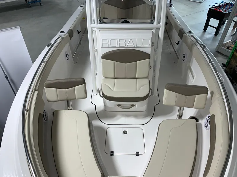 Slide: The Image of 2024 Robalo R222 Explorer boat interior with cushioned seating and storage compartments. - 15