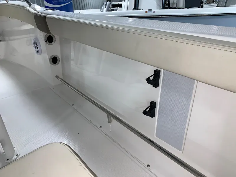 Slide: The Image of 2024 Robalo R222 Explorer boat interior, white seating and storage compartments. - 16