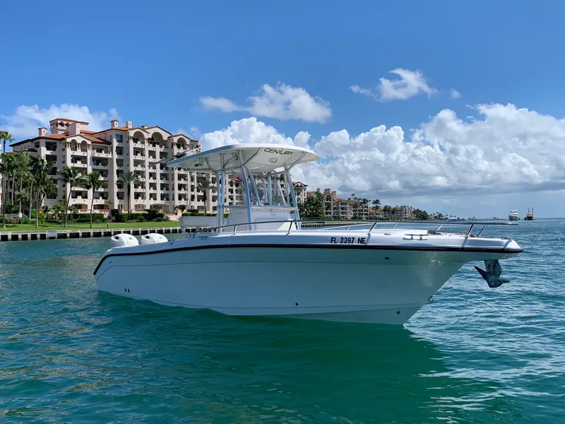 The Image of 2006 Century 2600CC boat on water with coastal buildings in the background. - 0