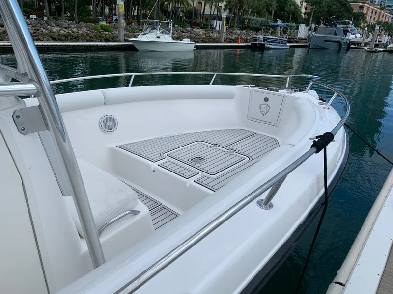 Slide: The Image of 2006 Century 2600CC boat docked in a marina, featuring spacious deck and sleek design. - 12