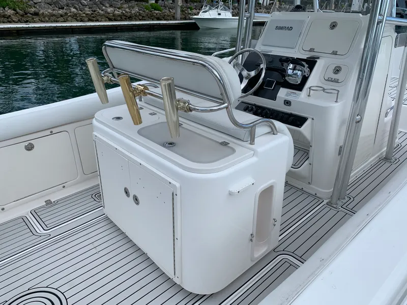 Slide: The Image of Century 2600CC 2006 boat interior with helm, rod holders, and Simrad electronics. - 14