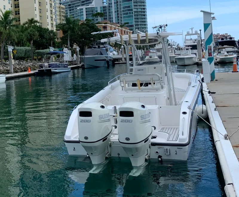Slide: The Image of Century 2600CC 2006 boat docked with twin Suzuki 200 engines in a marina setting. - 15