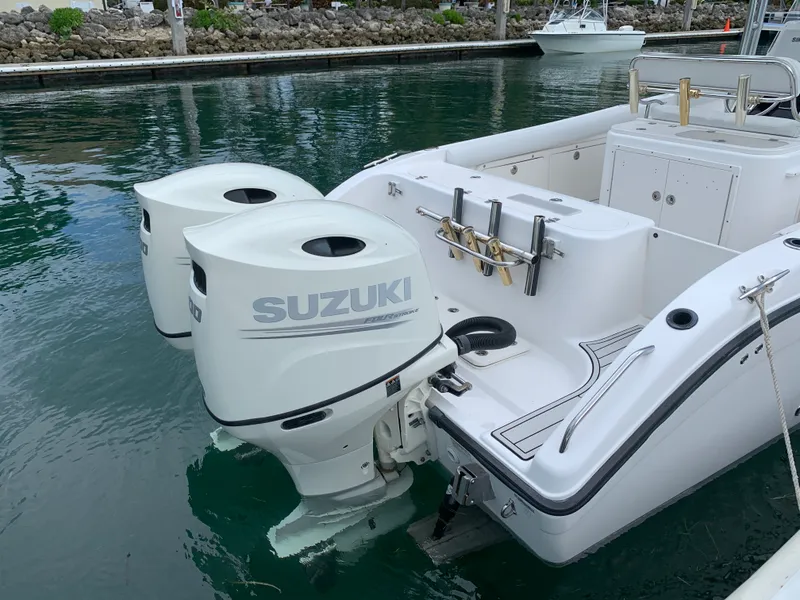 Slide: The Image of Century 2600CC 2006 boat with dual Suzuki outboard motors docked in marina. - 16