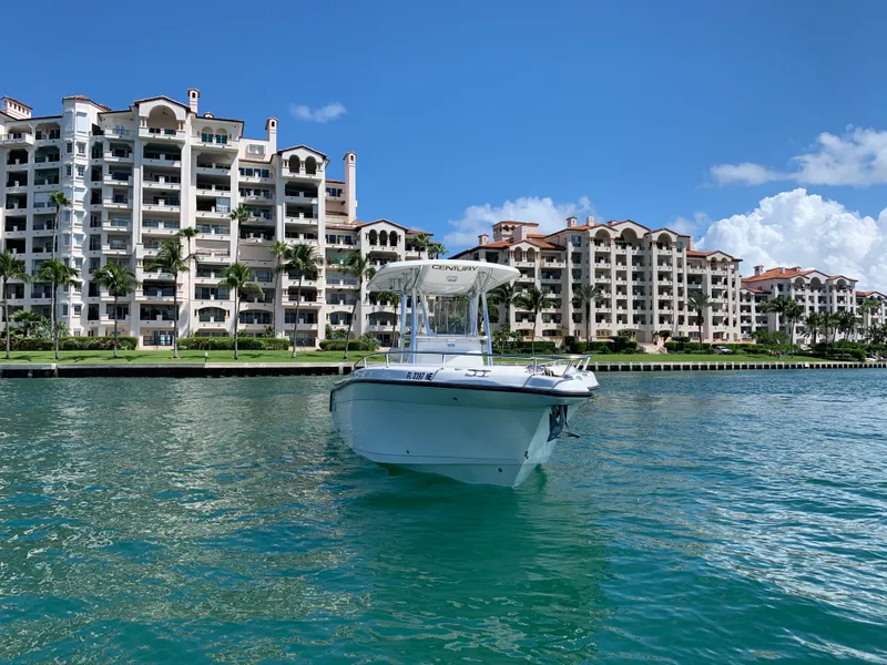 Slide: The Image of A 2006 Century 2600CC boat on water with luxury waterfront apartments in the background. - 3