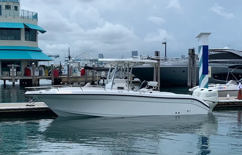 Slide: The Image of 2006 Century 2600CC boat docked at marina with overcast sky. - 6