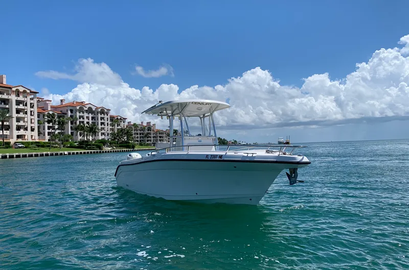Slide: The Image of Century 2600CC boat on water near luxury waterfront buildings, under a clear blue sky. - 8