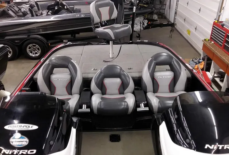 Slide: The Image of 2015 Nitro Z-8 DC boat with gray seats in a garage. - 26