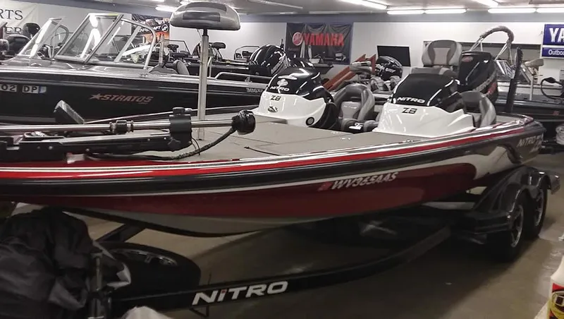 Slide: The Image of 2015 Nitro Z-8 DC boat in showroom, red and black. - 5