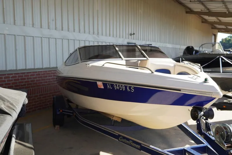 Slide: The Image of 2002 Stingray 180LX boat on trailer in storage facility. - 3