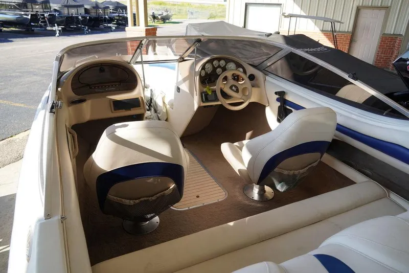 Slide: The Image of Interior of a 2002 Stingray 180LX boat with steering wheel and seating. - 5