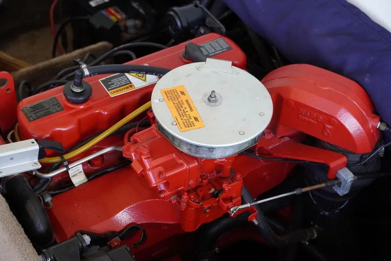 Slide: The Image of 2002 Stingray 180LX boat engine close-up with red components and wiring. - 6