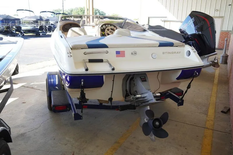 Slide: The Image of 2002 Stingray 180LX boat on trailer, rear view in a storage facility. - 7