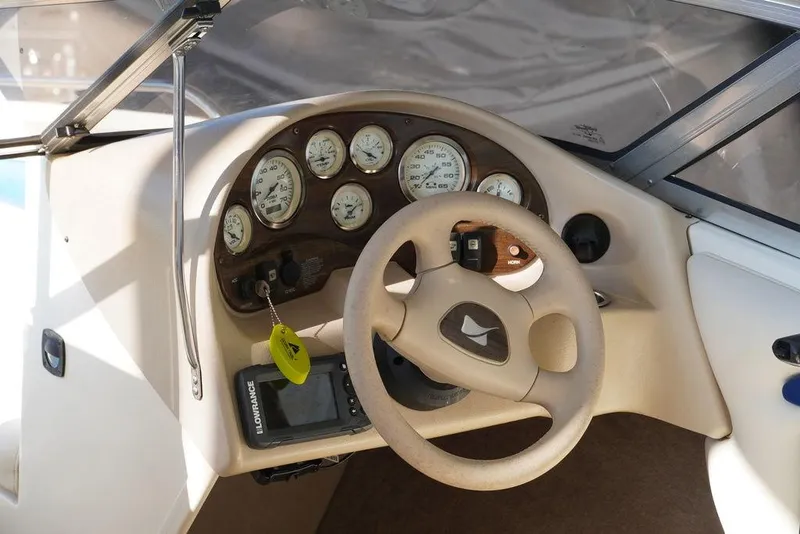 Slide: The Image of 2002 Stingray 180LX boat dashboard with steering wheel and gauges. - 8