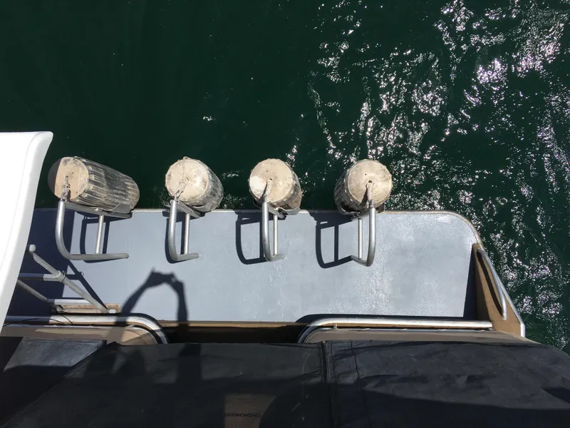 Slide: The Image of View from a 1996 Stardust Cruisers boat, docked with fenders on the water. - 10