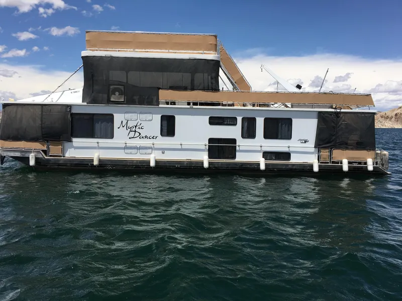 Slide: The Image of 1996 Stardust Cruisers houseboat on water, named Mystic Dancer, with upper deck and awnings. - 3