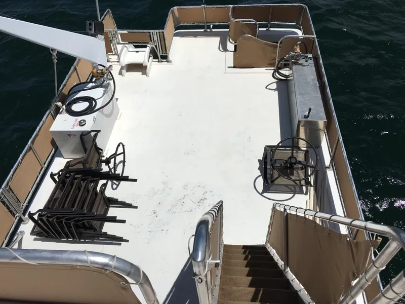 Slide: The Image of Top deck of 1996 Stardust Cruisers houseboat, spacious layout with railings and equipment. - 6