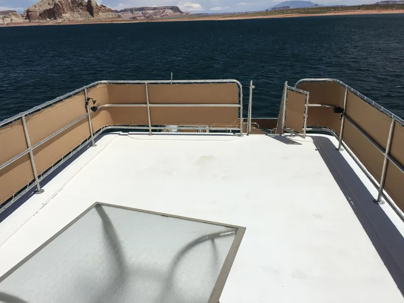 Slide: The Image of Top deck of a 1996 Stardust Cruisers houseboat on a lake with scenic views. - 7