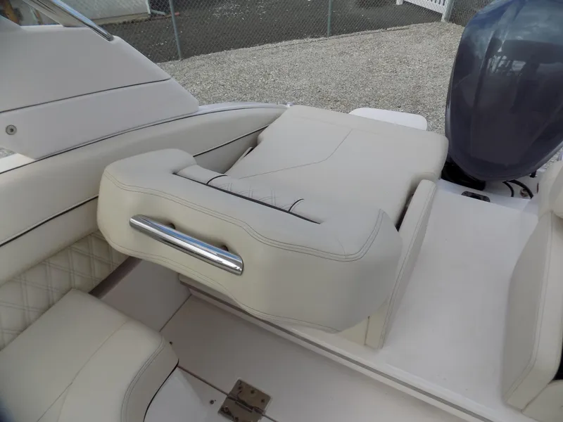 Slide: The Image of 2021 Regal LX6 boat interior with white leather seating and stainless steel handle. - 14