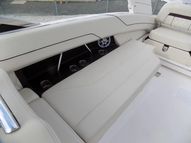 Slide: The Image of Luxurious seating on 2021 Regal LX6 boat with cup holders and speaker. - 16