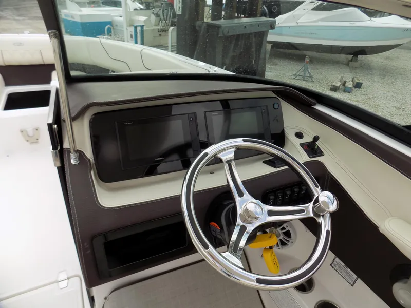 Slide: The Image of 2021 Regal LX6 boat dashboard with steering wheel and digital displays. - 8