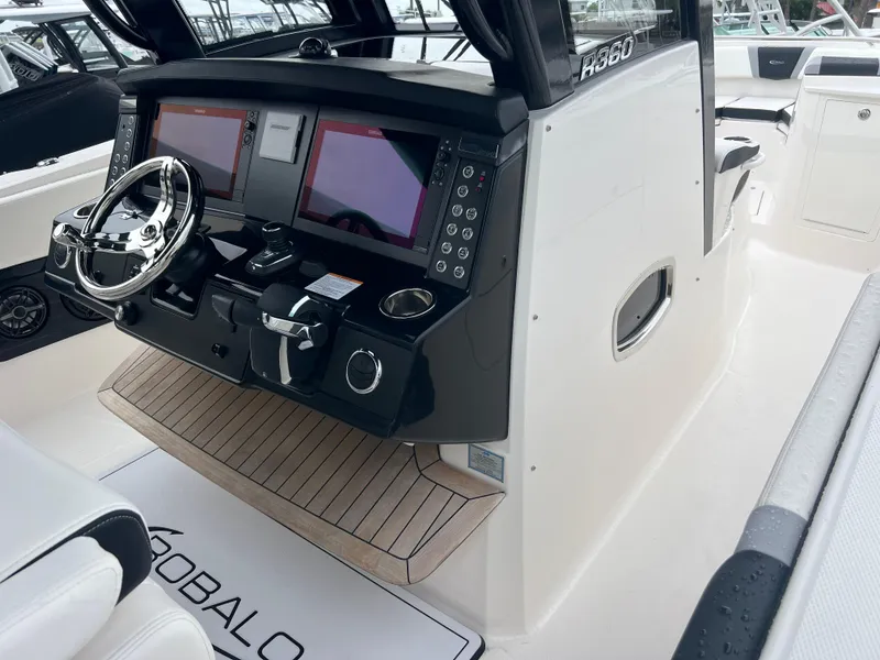 Slide: The Image of 2024 Robalo R360 boat cockpit with dual screens and modern controls. - 10