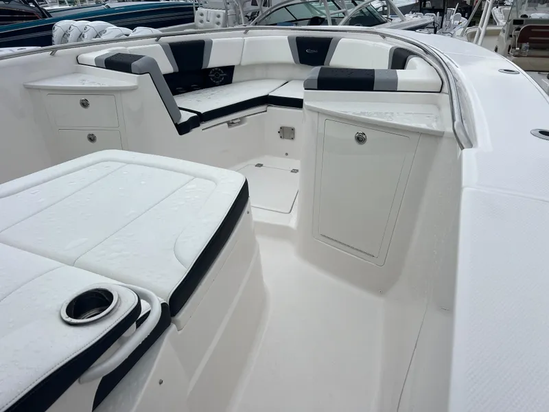 Slide: The Image of 2024 Robalo R360 boat interior with sleek seating and storage compartments. - 12