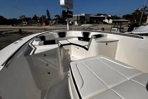 Slide: The Image of 2024 Robalo R360 boat interior with white seating and storage compartments. - 13