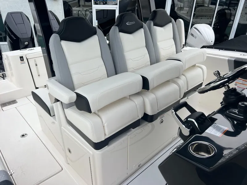 Slide: The Image of 2024 Robalo R360 boat interior with luxurious white and black seating. - 17