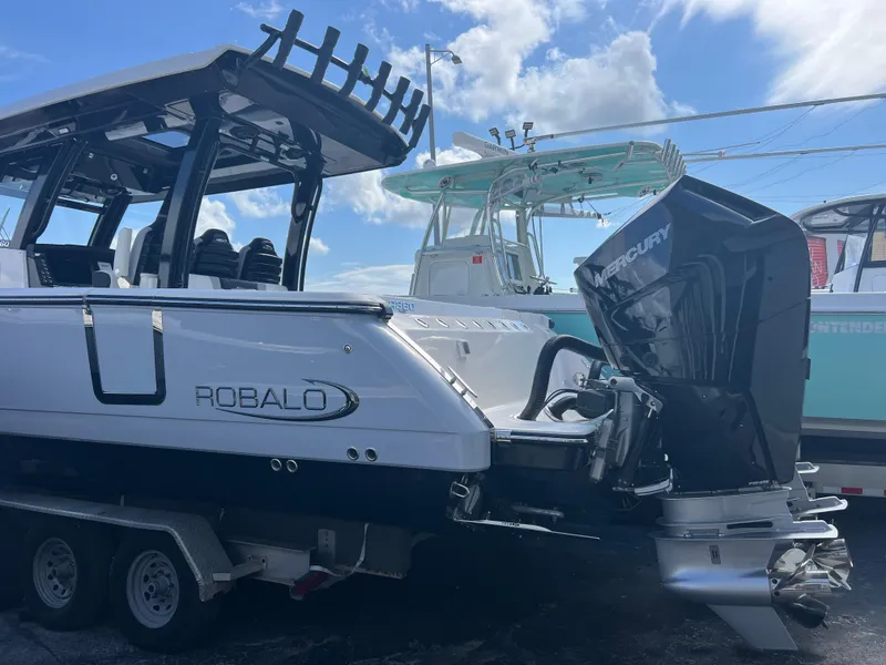 Slide: The Image of 2024 Robalo R360 boat with Mercury engine on trailer, under blue sky. - 3