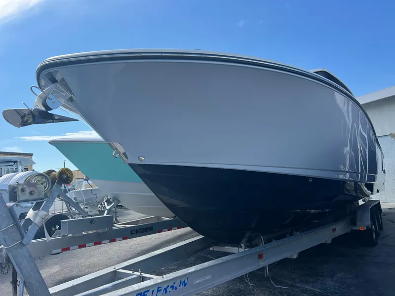 Slide: The Image of 2024 Robalo R360 boat on trailer under clear blue sky. - 5