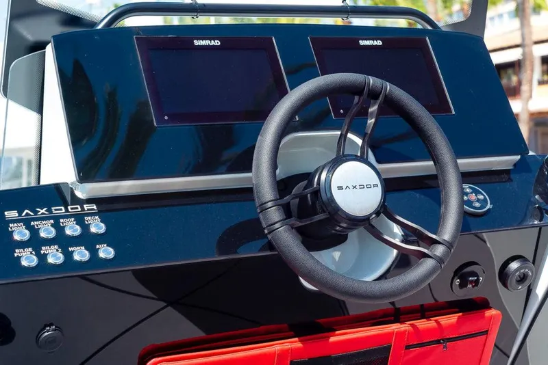 Slide: The Image of Steering console of the 2023 Saxdor 200 SPORT boat with dual Simrad displays. - 10