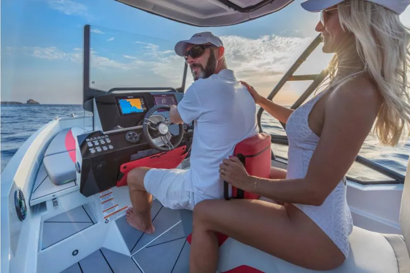 Slide: The Image of 2023 Saxdor 200 SPORT boat with a couple enjoying a sunny day on the water. - 15