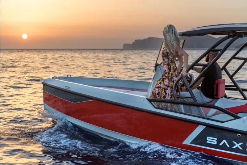 Slide: The Image of 2023 Saxdor 200 SPORT boat cruising at sunset with passengers. - 16