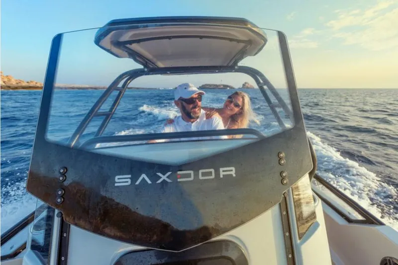 Slide: The Image of Couple enjoying a ride on a 2023 Saxdor 200 SPORT boat. - 23