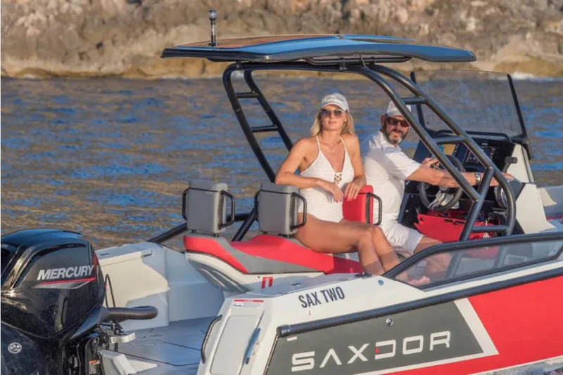 Slide: The Image of 2023 Saxdor 200 SPORT boat on water with two people onboard. - 24